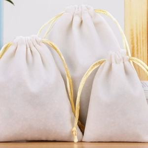 Three premium white velvet drawstring pouches with gold cords in various sizes