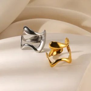 Minimalist gold and silver wavy open rings in a modern streamlined polished metal design