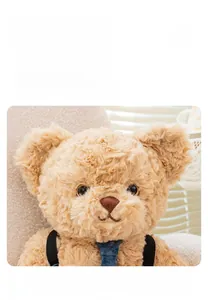 Close-up of teddy bear plush toy showing soft brown faux fur and denim tie details