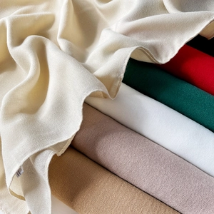 Close-up of lightweight cotton linen scarves showing various colors and soft texture detail