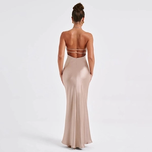 Detail of champagne satin backless dress featuring elegant cross straps and mermaid hem