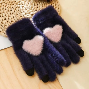 Detail of navy faux mink gloves featuring pink heart motifs and black touchscreen fingertips