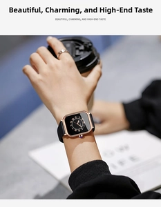Close-up of a women's square rose gold quartz watch with a black silicone strap and dial