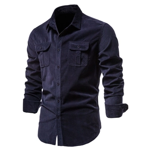 Detail of dark blue corduroy shirt featuring double breast pockets and textured fabric