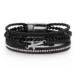 Detail of multi-layer beaded bracelet with silver cross charm and magnetic clasp