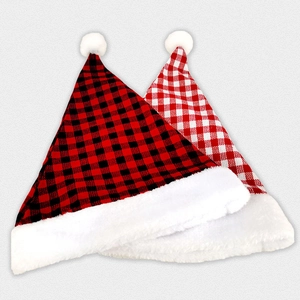 Detail of red black and red white plaid Christmas hats with soft plush trim and faux fur pom