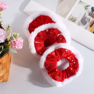 Detailed view of red velvet Christmas scrunchies with white faux fur and silver sequins
