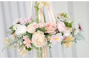 Detailed view of pink and beige floral hanging decoration with hanging crystal beads