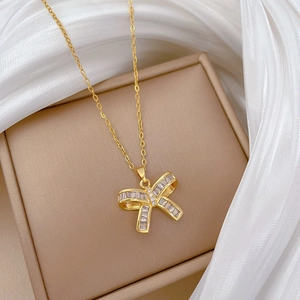 Elegant gold butterfly necklace with zircon pavé stones on a premium velvet jewelry box
