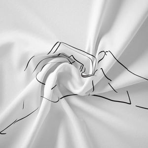 Macro shot of minimalist line art camera print on white fabric texture