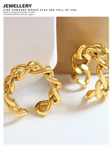 Macro detail of golden cuban link chain ring with a high-polished finish and open band