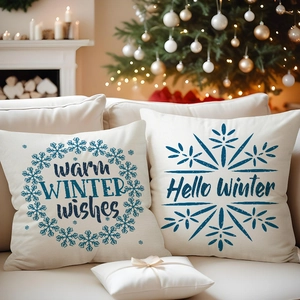 Close-up of blue winter theme linen pillowcases with holiday greetings on a cozy sofa