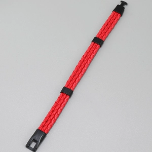 Macro detail of red braided leather bracelet with black magnetic clasp mechanism