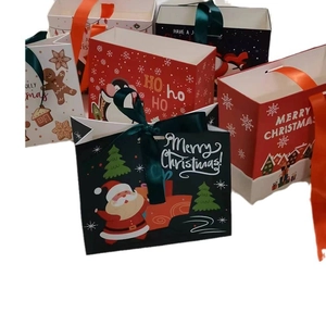 Detail of Christmas gift bags with ribbon handles and festive patterns like Santa and trees