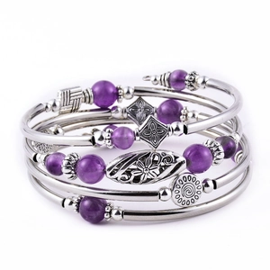 Detail of bohemian wrap bracelet featuring purple beads and silver-toned textured metal charms