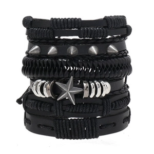 Detail of multi-layer black leather punk bracelet with metal studs and star charms