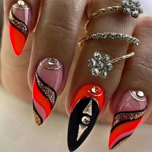 French neon orange and black stiletto press-on nails with gold glitter and rhinestones