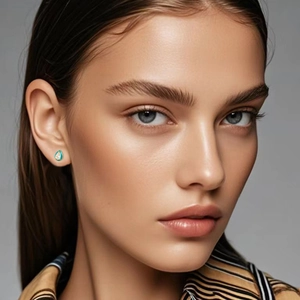 Close-up of S925 silver water drop stud earring with blue enamel on a model