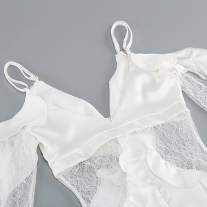 Detailed close-up of white satin camisole featuring delicate lace trim and ruffle details