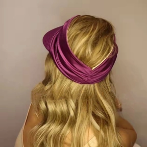 Detail of dark purple satin sun visor headband showing back elastic pleated design