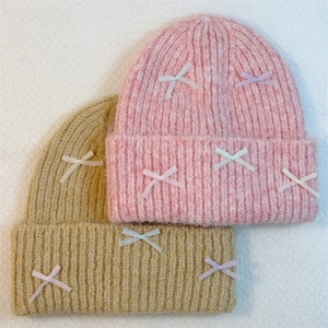 Pink and khaki ribbed knit beanies with tiny ribbon bows for autumn and winter warmth
