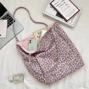 Detail of pink leopard print tote bag interior lining and spacious structure for commute
