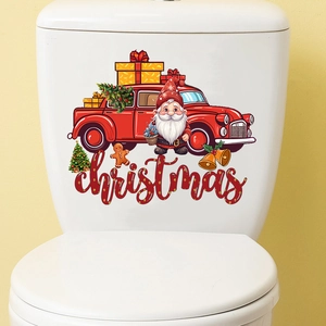 Close-up of Christmas toilet stickers featuring a vintage red truck and a festive tree