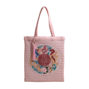 Pink straw woven tote bag with dragon phoenix embroidery and silk tassel detail