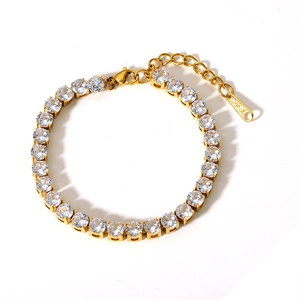 Detail of gold tennis bracelet with zircon stones, lobster clasp, and 14K tag