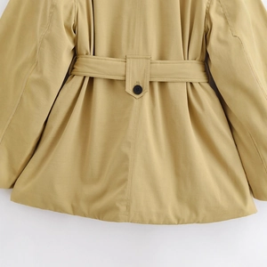 Close-up of khaki casual jacket showing waistband detail and black button closure