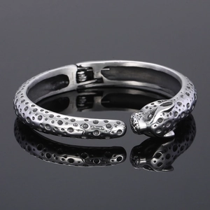 Macro shot of silver leopard head open bangle with detailed punk leopard spots engraving