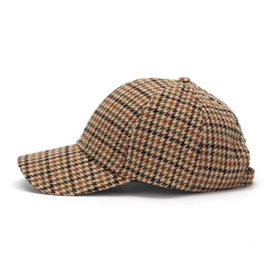 Side view of houndstooth baseball cap in brown tweed showing refined texture and curved brim
