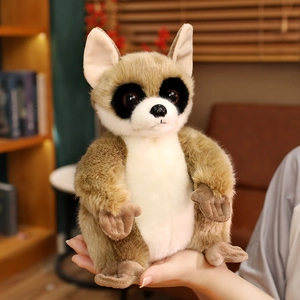 Plush lemur toy with large eyes held in hand, soft brown and beige furry stuffed animal