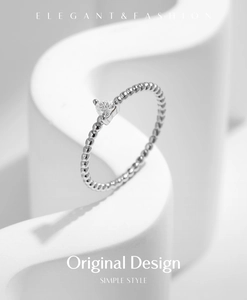 Macro shot of s925 silver beaded ring featuring a heart-shaped moissanite on a wavy stand