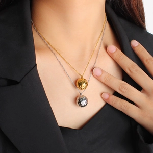 Elegant 18K gold textured ball pendant double-layered necklace shown on female model