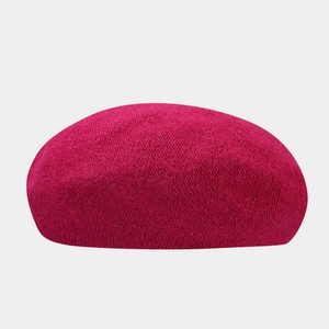 Close-up of deep magenta knit rabbit fur beret showing soft texture and warm fabric