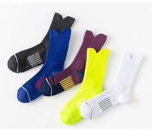 Detail view of five assorted sports crew socks showing arch support and breathable knit texture