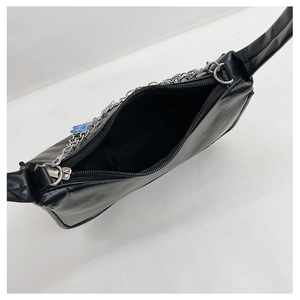 Detail view of the black PU leather shoulder bag with silver chain and zipper closure