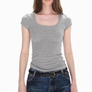 Detail shot of the tight-fit grey U-neck short sleeve tee paired with blue denim jeans