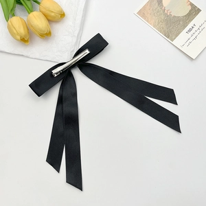 Elegant black satin double-layered bow hair clip with long ribbons on white background