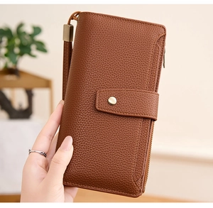 Close-up of brown litchi pattern PU leather wallet with wrist strap and secure clasp