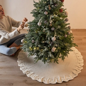 Creamy beige knit Christmas tree skirt with thick braided embossed edges for home decor