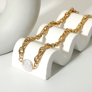 Detail shot of 18K gold-plated chain necklace with flat round pearl on wave stand