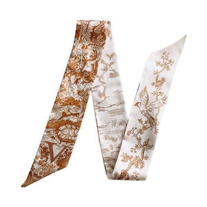 Detail of an ivory twilly silk scarf with orange-brown animal and botanical illustrations