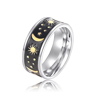 Macro detail of silver stainless steel ring featuring celestial sun moon and star motifs