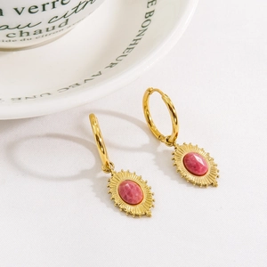 Bohemian 14K gold maple leaf earrings with pink rhodochrosite on white textured fabric