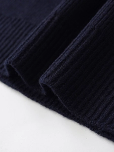 Macro shot of dark blue ribbed knit fabric showing thick texture and soft fiber details