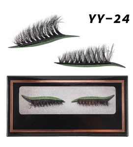 Macro view of fake eyelashes with green glitter eyeliner and elegant black packaging