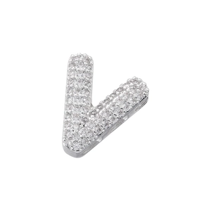 Macro view of silver letter V pendant with iced out pavé setting cubic zirconia stones
