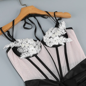 Detailed close-up of lace bodice with floral embroidery and white pearl embellishments